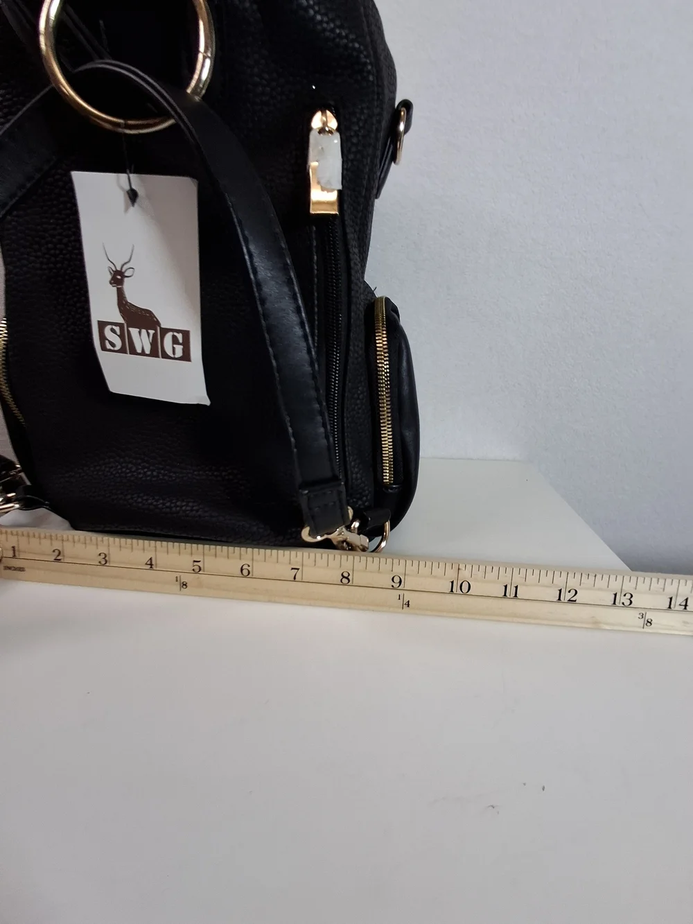 SWG Black Pebbled Sling Barrel Backpack with Gold Accents
